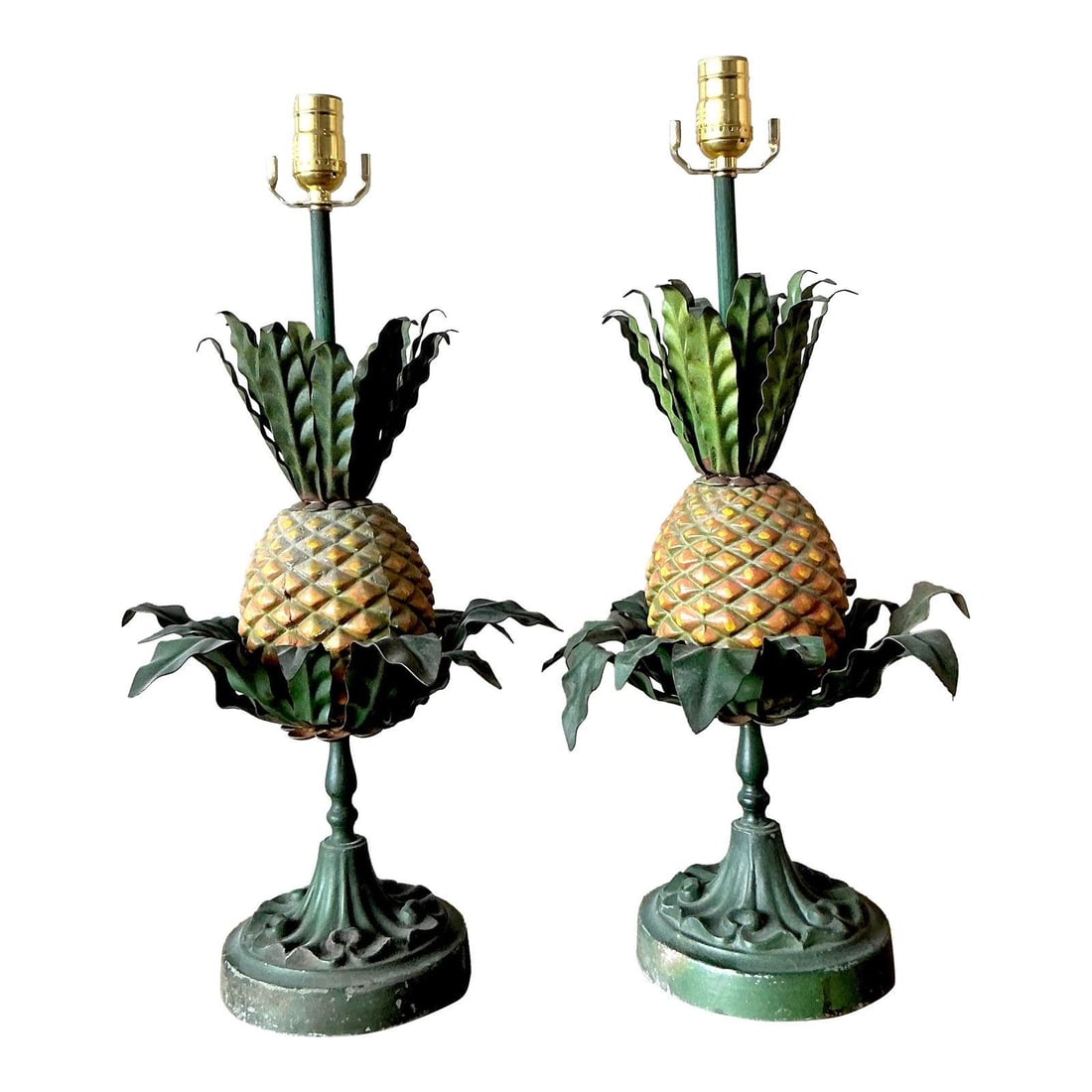 Pair of Painted Tole Pineapple Lamps With Verdigris Bases: Pair of Painted Tole Pineapple Lamps With Verdigris Bases This pair of vintage pineapple lamps is crafted from painted metal (tole) and features sculptural green leaves atop textured, painted bodies. 