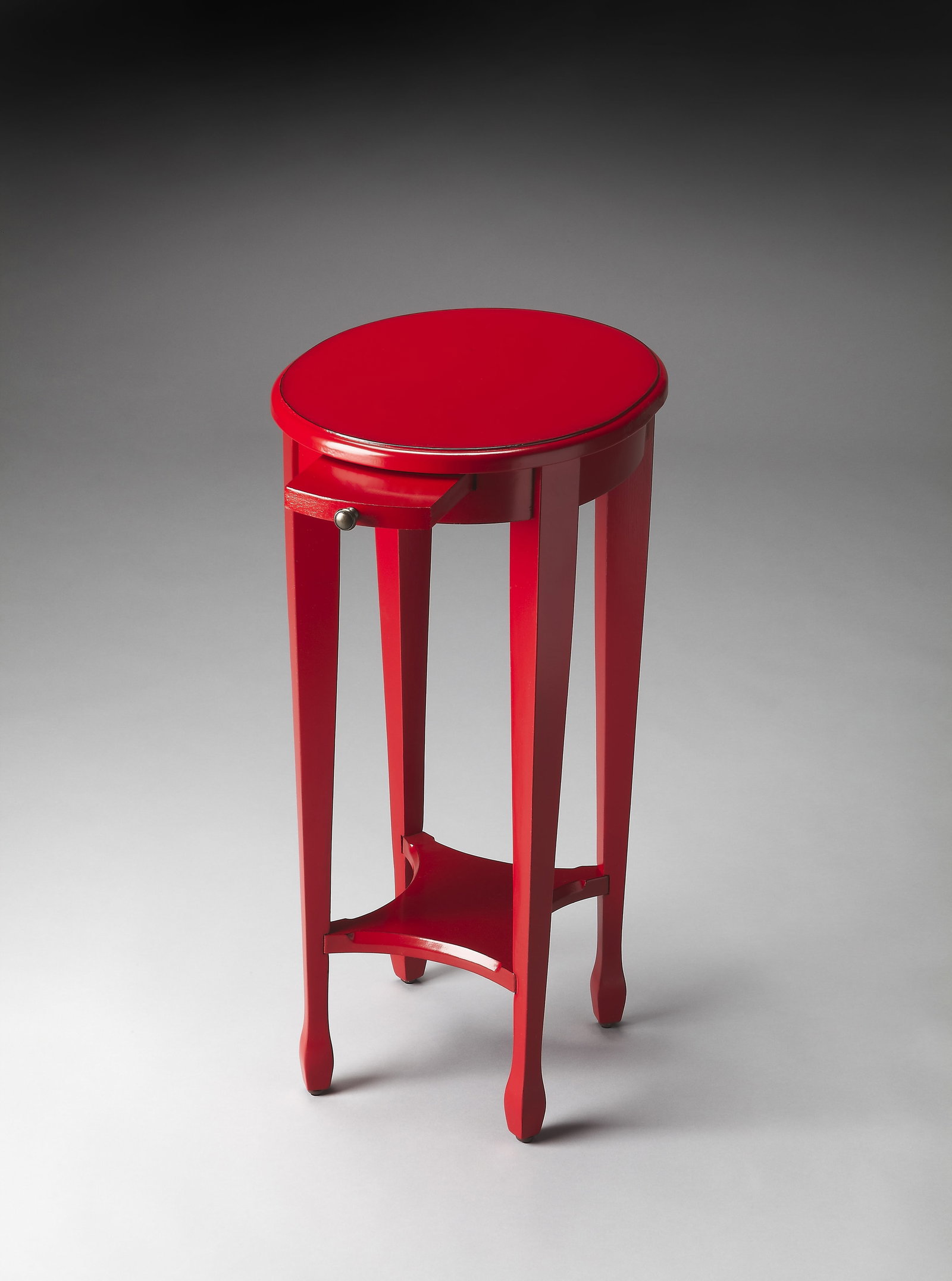 Butler Arielle Oval Red Side Table with Shelf: Butler Arielle Oval Red Side Table with Shelf This elegant oval side table from the Arielle collection by Butler is designed in a charming Regency style. Featuring a striking red finish, this hand-cra