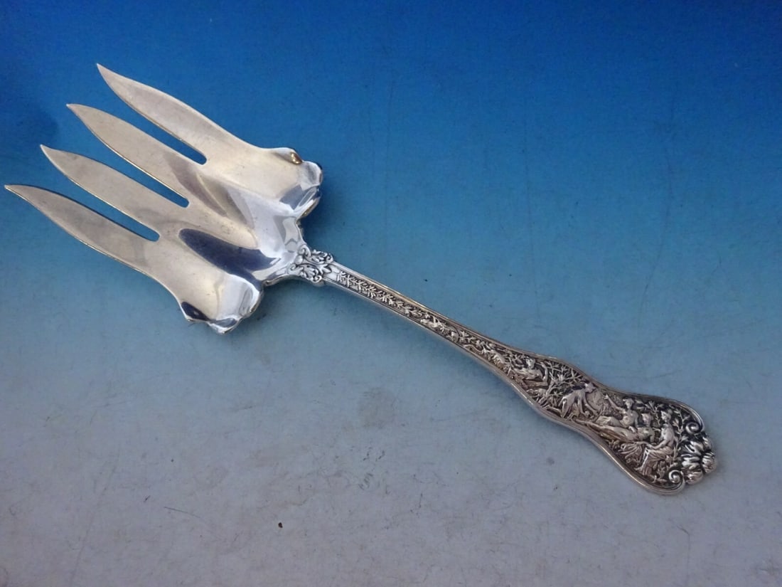 Tiffany & Co Olympian Sterling Silver Ruffled Serving Fork 9": Tiffany & Co Olympian Sterling Silver Ruffled Serving Fork 9" This exquisite serving fork from the Olympian pattern by Tiffany & Co. is crafted from high-quality sterling silver, showcasing a beautifu