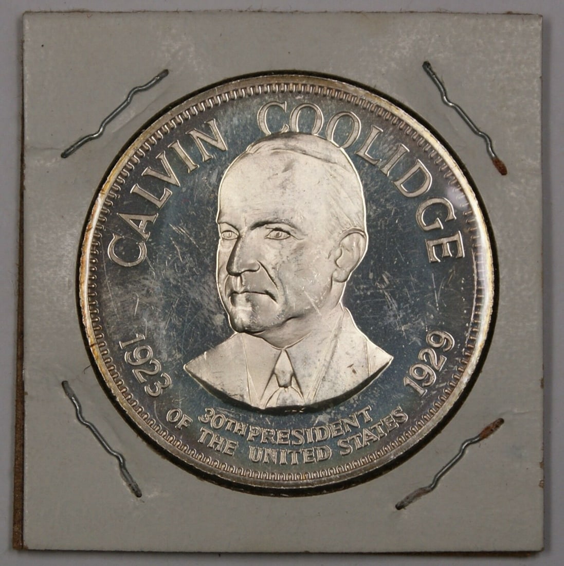 Silver Medal Honoring Calvin Coolidge 30th President with Reverse Details: Silver Medal Honoring Calvin Coolidge 30th President with Reverse Details This is a silver medal featuring Calvin Coolidge, the 30th President of the United States. The reverse side contains additiona