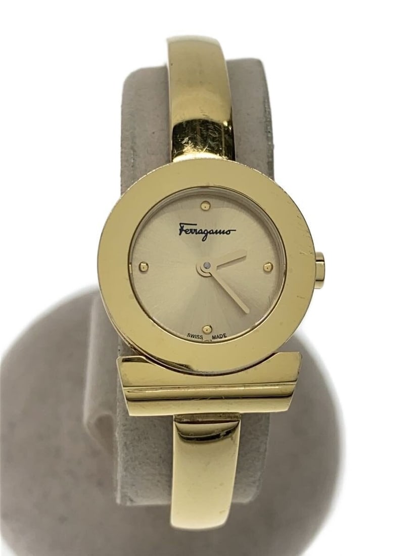 Salvatore Ferragamo Gold Stainless Steel Quartz Ladies Wristwatch: Salvatore Ferragamo Gold Stainless Steel Quartz Ladies Wristwatch This Salvatore Ferragamo Gancini quartz women's wristwatch features a gold-tone stainless steel case and band. Designed in Switzerland