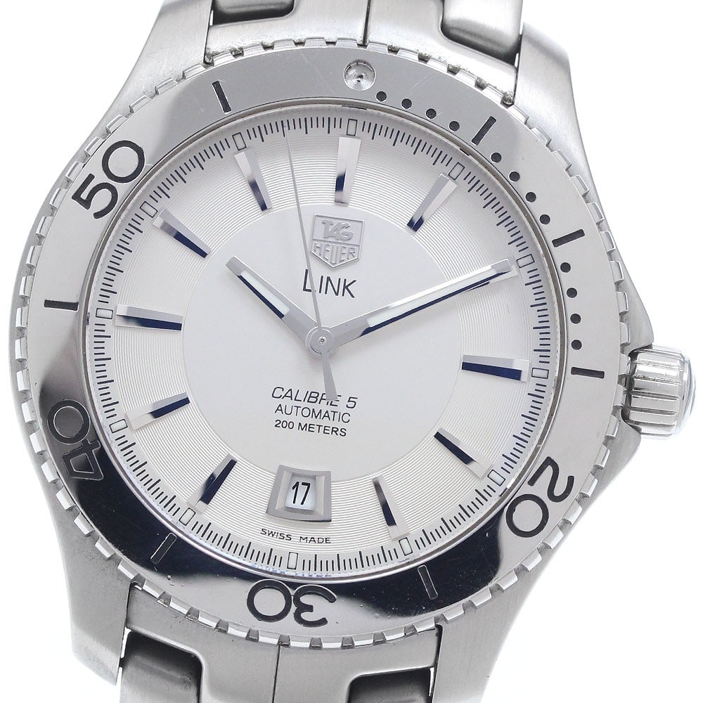 TAG Heuer Link WJ201B stainless steel automatic date watch: TAG Heuer Link WJ201B stainless steel automatic date watch This TAG Heuer Link Caliber 5 Automatic men's wristwatch features a stainless steel case and band with a silver dial. The watch has a date fu