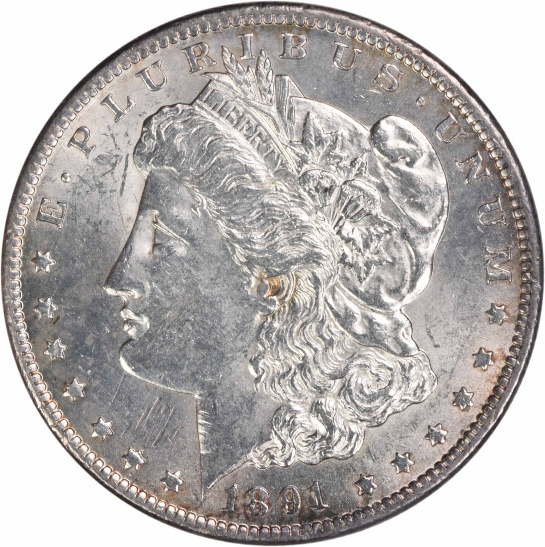 1891-CC Morgan Silver Dollar AU Uncertified 90% Silver Coin: 1891-CC Morgan Silver Dollar AU Uncertified 90% Silver Coin This 1891-CC Morgan Silver Dollar showcases the artistry of designer George T. Morgan. Struck in Carson City, this coin is composed of 90% s