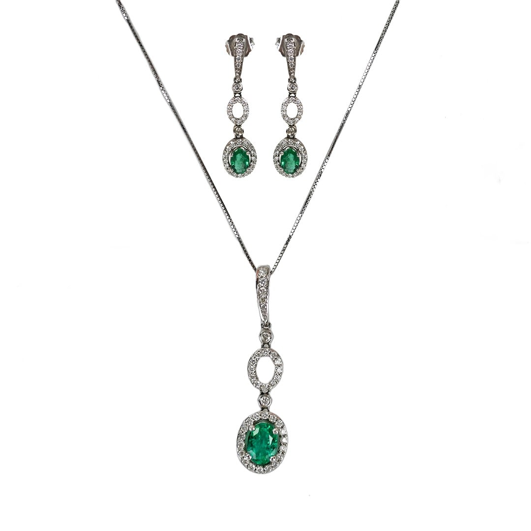 14K White Gold Emerald Diamond Jewelry Set Necklace Earrings: 14K White Gold Emerald Diamond Jewelry Set Necklace Earrings This elegant jewelry set features a pair of earrings and a pendant crafted in 14K white gold. The set showcases natural oval-shaped emerald