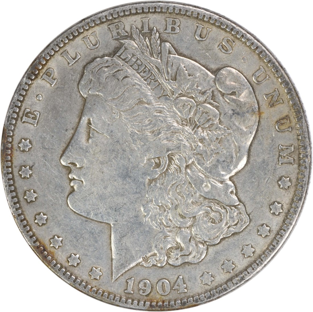 United States 1904 Morgan Dollar EF 90 Percent Silver Uncertified Coin: United States 1904 Morgan Dollar EF 90 Percent Silver Uncertified Coin This 1904 Morgan Silver Dollar was minted in Philadelphia and features a composition of 90% silver and 10% copper. Designed by Ge
