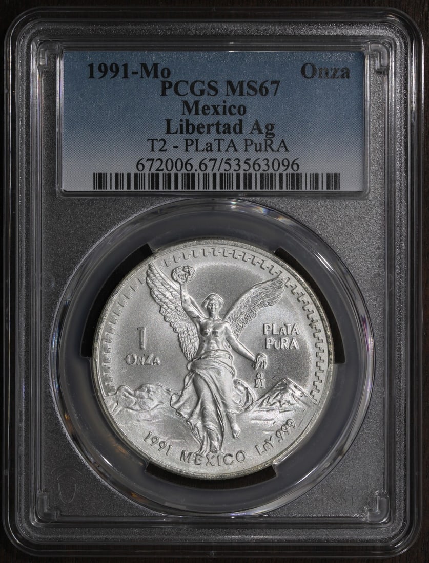 1991 Mexico Silver Libertad Onza 1 oz PCGS MS67 Type 2: 1991 Mexico Silver Libertad Onza 1 oz PCGS MS67 Type 2 This 1991 Mexican Libertad 1 oz silver coin is struck from .999 fine silver and graded MS 67 by PCGS. Recognized as a key date, it features the i