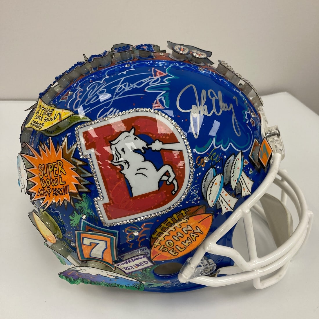 John Elway autographed Denver Broncos Riddell helmet with COA: John Elway autographed Denver Broncos Riddell helmet with COA This full-size authentic Riddell Denver Broncos helmet features vibrant pop art by Charles Fazzino and is signed by John Elway. The helmet