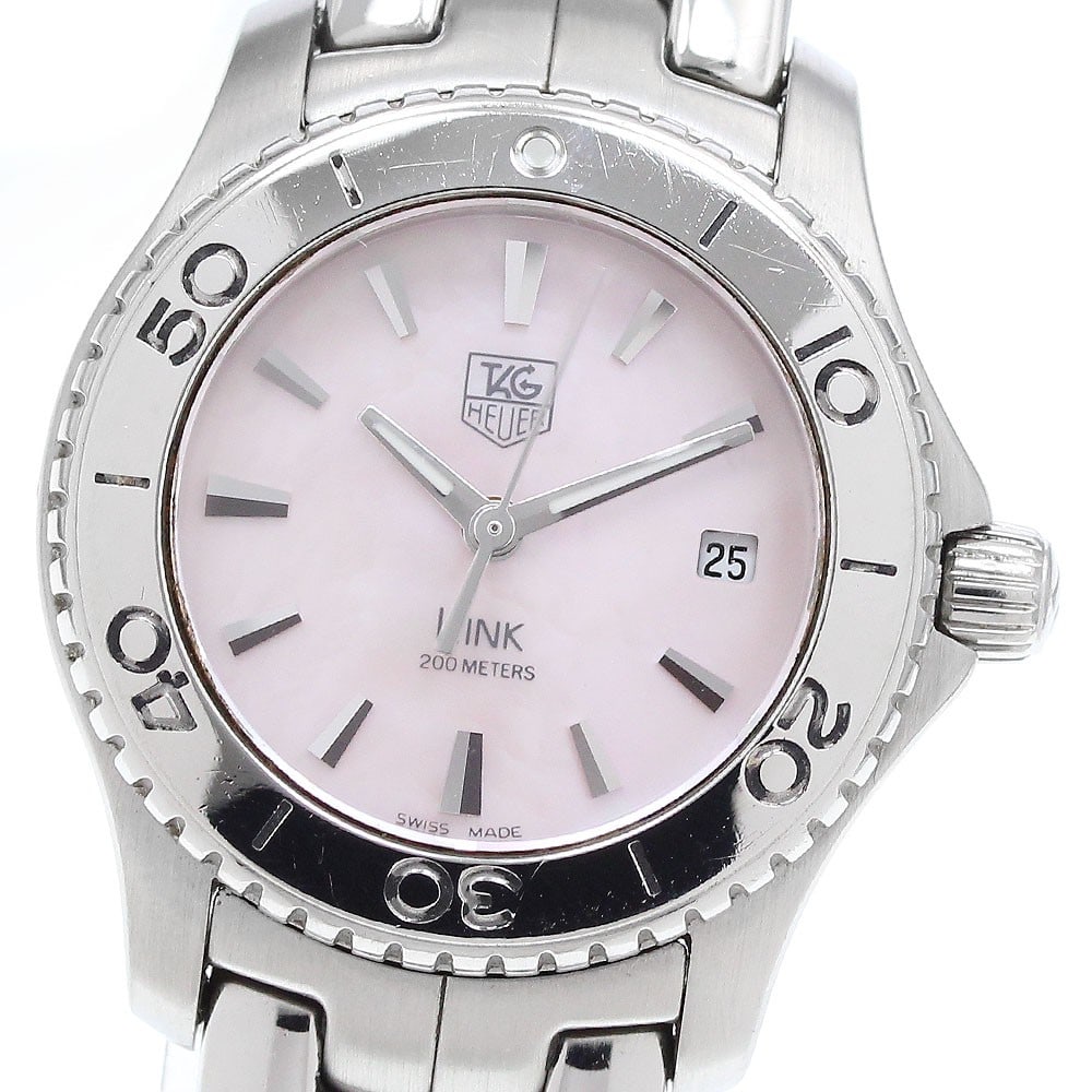 TAG Heuer Link Pink Shell Quartz Date Watch WJ1315-1: TAG Heuer Link Pink Shell Quartz Date Watch WJ1315-1 This TAG HEUER Link Date Quartz women's wristwatch features a stainless steel case and bracelet with a distinctive pink shell dial. The watch is po