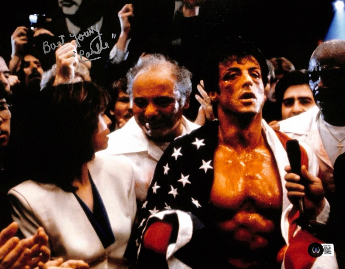 Burt Young Signed 11x14 Photo as Paulie with Beckett Authentication: Burt Young Signed 11x14 Photo as Paulie with Beckett Authentication This is an 11x14 autographed photograph featuring Burt Young in his role as "Paulie Pennino" from the movie Rocky. The photo is sign