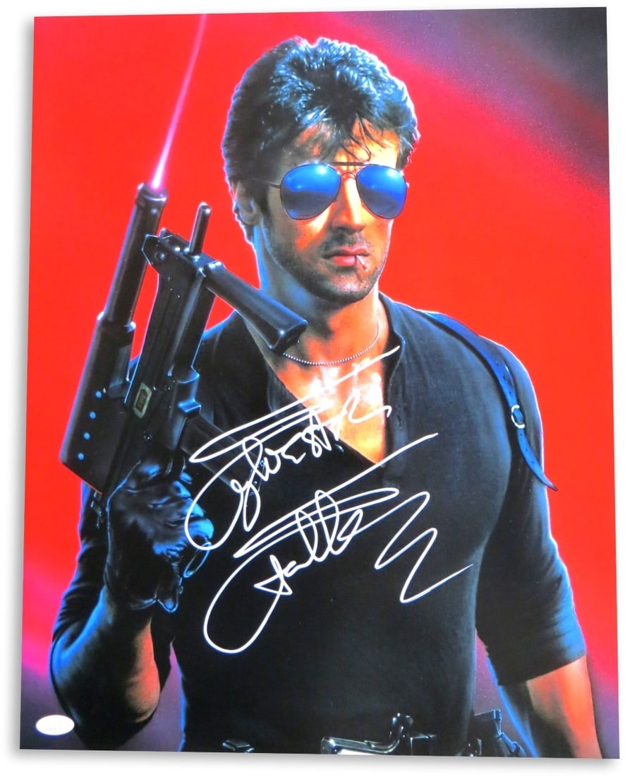 Sylvester Stallone Autographed 16X20 Photo Cobra with Gun JSA Authenticated: Sylvester Stallone Autographed 16X20 Photo Cobra with Gun JSA Authenticated This stunning 16" x 20" photograph features a striking image of Sylvester Stallone in character from the film "Cobra," holdi
