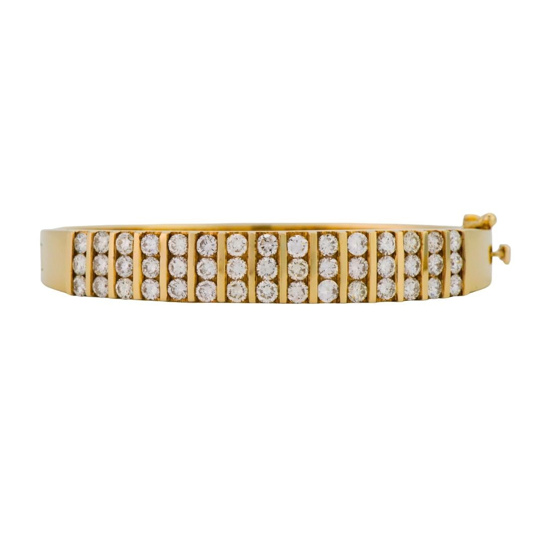 14K Yellow Gold Diamond Safety Clasp Bangle Bracelet 6 inch: 14K Yellow Gold Diamond Safety Clasp Bangle Bracelet 6 inch This pre-owned bangle bracelet is crafted from 14K yellow gold and features natural diamonds with a total carat weight ranging from 2.00 to 