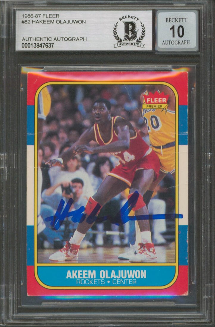 Hakeem Olajuwon Signed 1986 Fleer Rookie Card BAS Graded: Hakeem Olajuwon Signed 1986 Fleer Rookie Card BAS Graded This authentic 1986 Fleer #82 rookie card features Hakeem Olajuwon, a legendary player of the Houston Rockets. Personally signed by Olajuwon, t