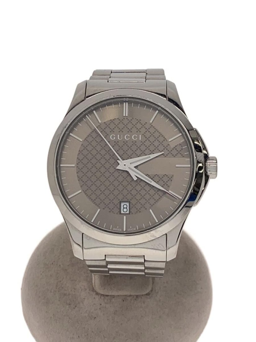 Gucci G Timeless Men's Quartz Wristwatch Camel Swiss: Gucci G Timeless Men's Quartz Wristwatch Camel Swiss This is a pre-owned Gucci G-Timeless quartz men's wristwatch in camel color. The watch features a Swiss-made movement and displays slight signs of 