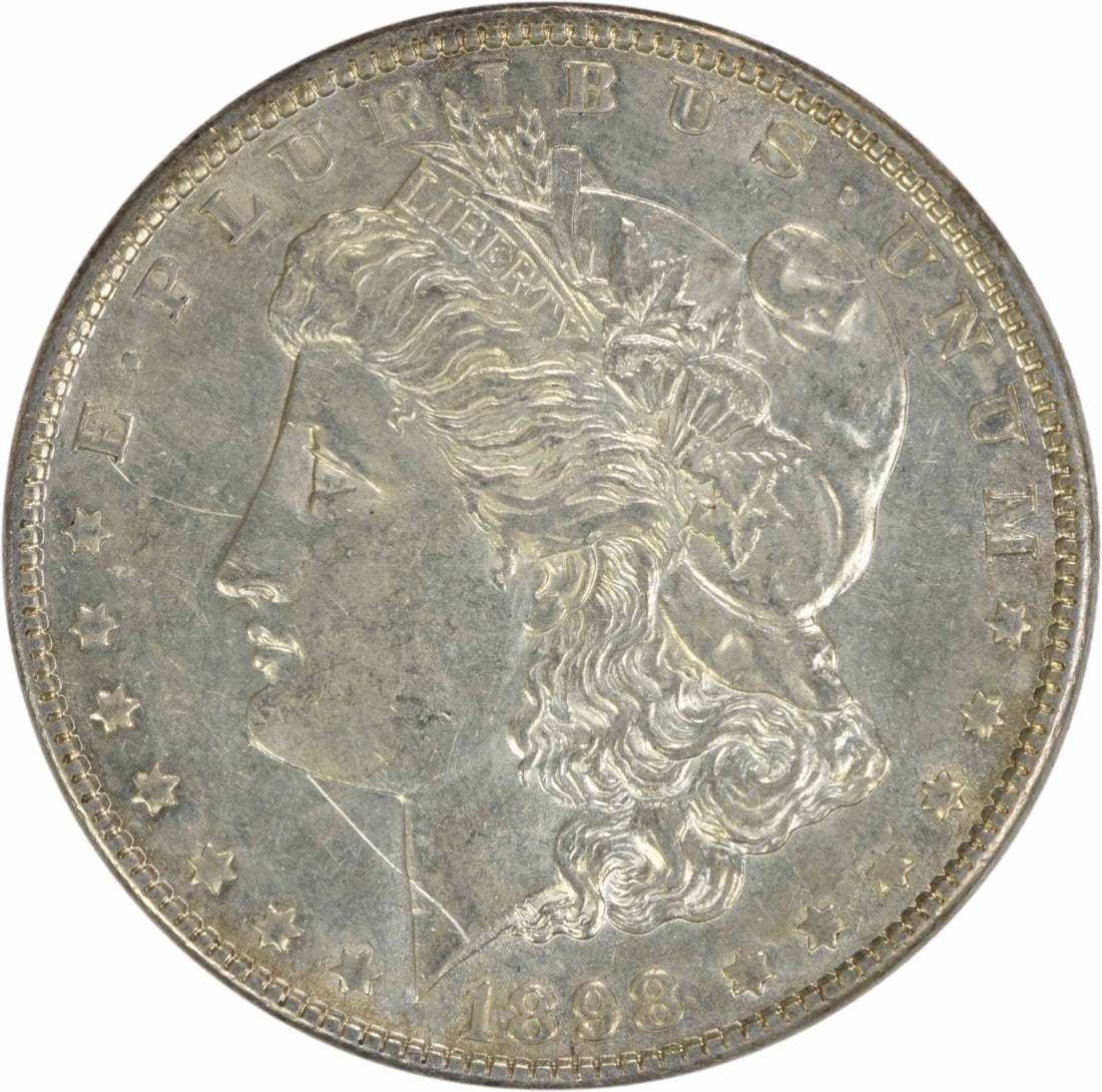 1898 Morgan Silver Dollar AU Uncertified 90% Silver Coin: 1898 Morgan Silver Dollar AU Uncertified 90% Silver Coin This 1898 Morgan Silver Dollar is a remarkable piece of numismatic history, featuring a grade of AU (Almost Uncirculated). Struck in 90% silver