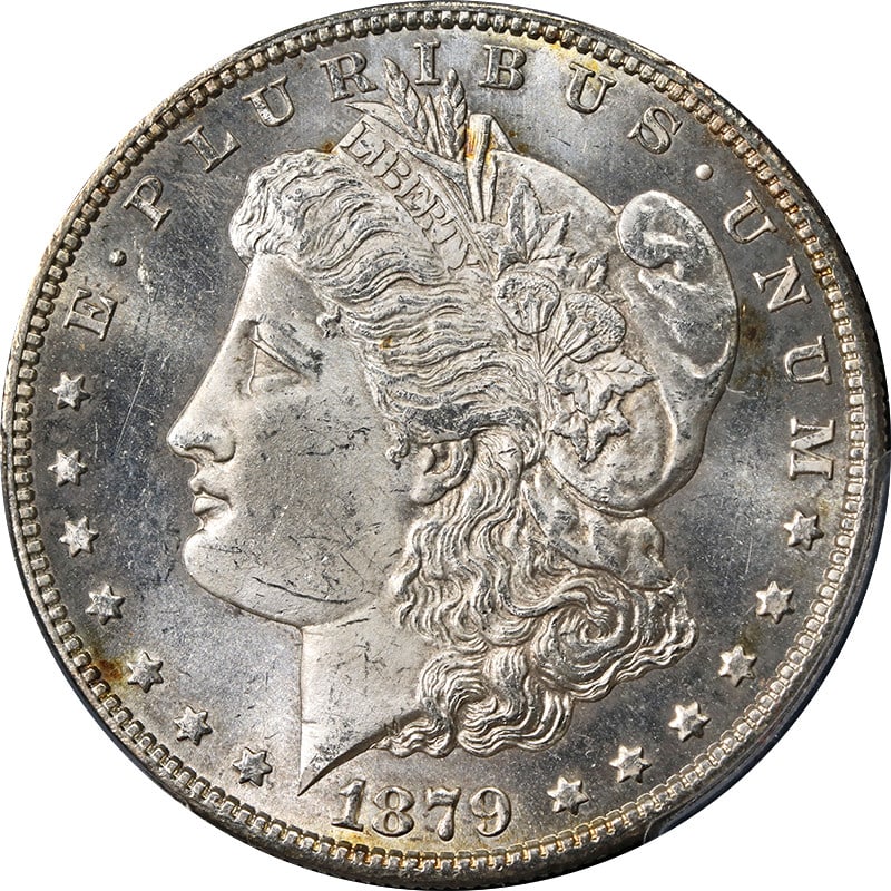 PCGS MS64 1879-S Morgan Silver Dollar With Attractive Toning: PCGS MS64 1879-S Morgan Silver Dollar With Attractive Toning This 1879-S Morgan Silver Dollar is certified by PCGS with a grade of MS64, indicating it is uncirculated and in excellent condition. The c