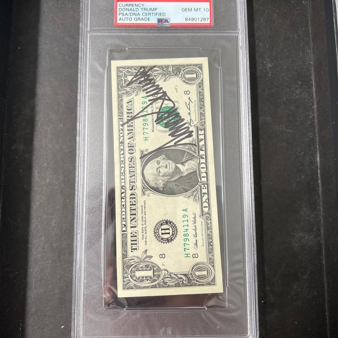 Donald Trump Signed Dollar Bill PSA/DNA Authenticated Grade 10: Donald Trump Signed Dollar Bill PSA/DNA Authenticated Grade 10 This is a dollar bill personally signed by Donald Trump, the 45th President of the United States. The signature has been verified by PSA/