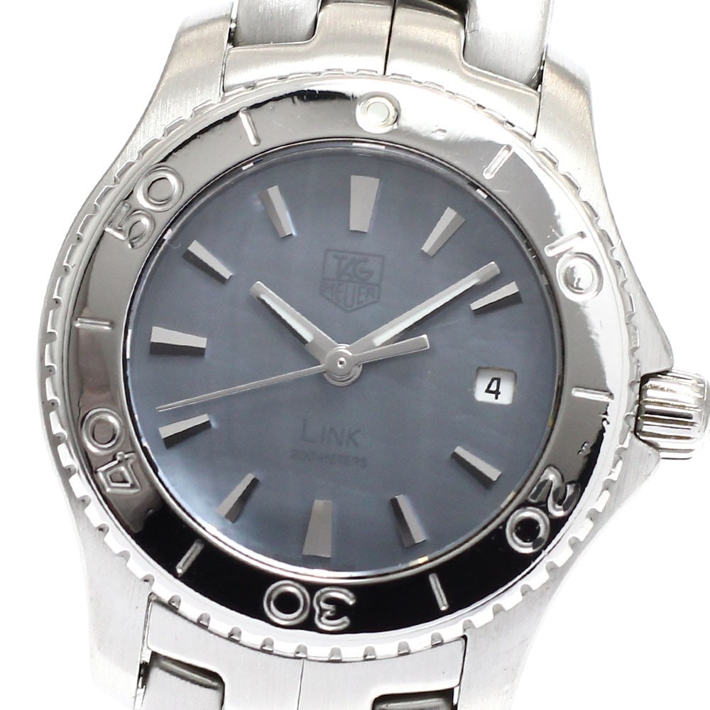 TAG Heuer Link blue shell quartz date ladies watch WJ1316-0: TAG Heuer Link blue shell quartz date ladies watch WJ1316-0 This TAG HEUER Link Date Quartz women's wristwatch, model WJ1316-0, features a stainless steel case and bracelet with a blue shell dial. The
