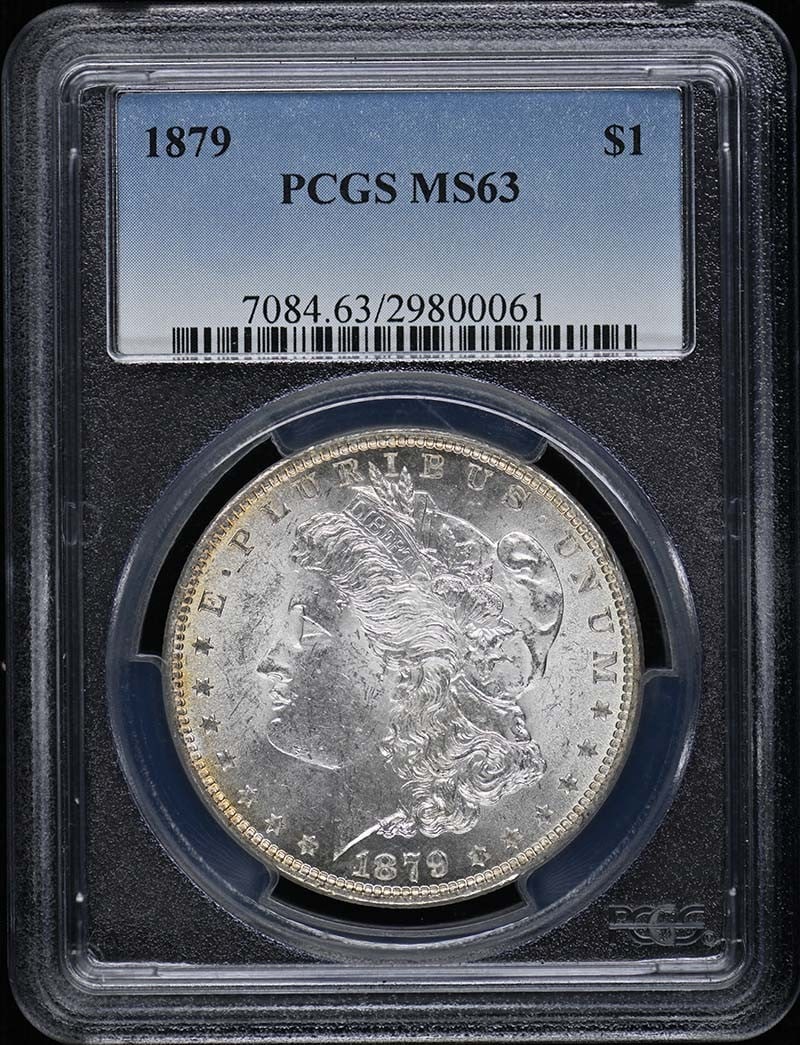 PCGS MS63 1879 Morgan Silver Dollar: PCGS MS63 1879 Morgan Silver Dollar This is an 1879 Morgan Dollar graded MS63 by PCGS. The coin is uncirculated and was minted in Philadelphia. It is a pre-owned collectible from the United States, fe