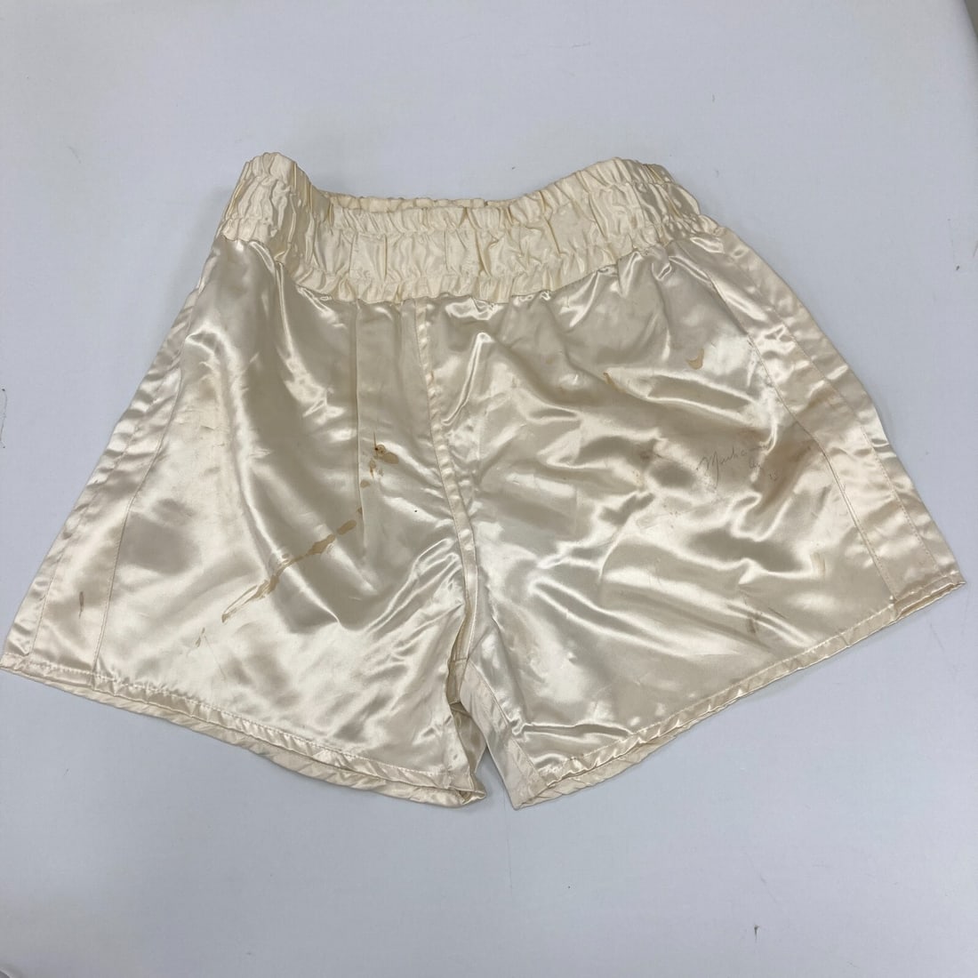 Muhammad Ali Signed Fight Worn Everlast Trunks with PSA DNA COA: Muhammad Ali Signed Fight Worn Everlast Trunks with PSA DNA COA Own a piece of boxing history with these Muhammad Ali signed and potentially fight-worn Everlast trunks. Known as 'The Greatest,' Muhamm