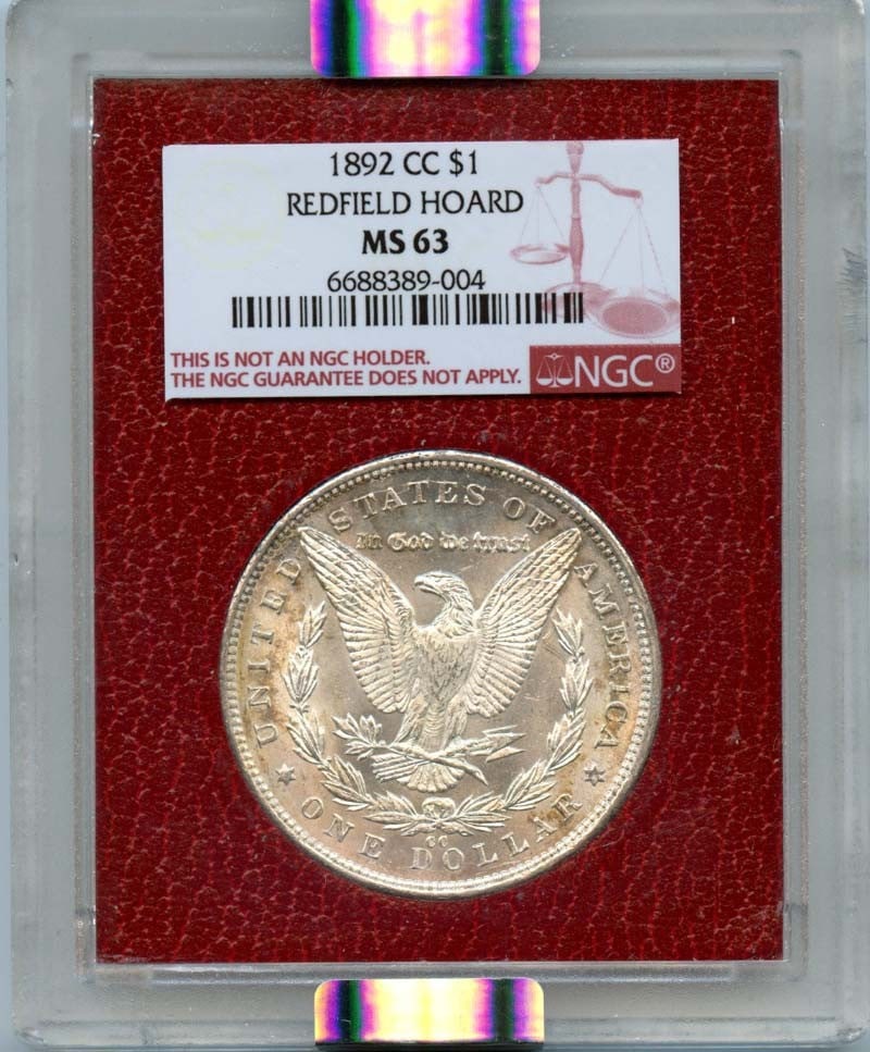 1892-CC Morgan Dollar NGC MS63 Redfield Hoard Uncirculated: 1892-CC Morgan Dollar NGC MS63 Redfield Hoard Uncirculated This 1892-CC Morgan Dollar is a remarkable piece from the Redfield Hoard, certified by NGC with a grade of MS63. Struck at the Carson City Mi