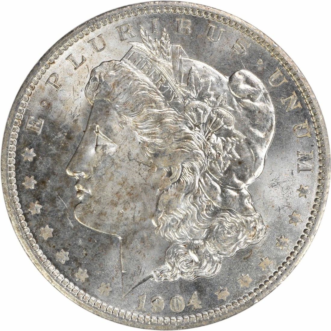 Uncirculated 1904 O Silver Morgan Dollar Brilliant Uncertified US Coin: Uncirculated 1904 O Silver Morgan Dollar Brilliant Uncertified US Coin This is a 1904-O Morgan Silver Dollar from the United States, featuring bright uncirculated (BU) condition. The coin is composed 