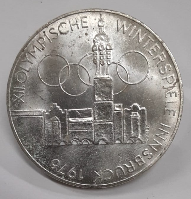 Austria 100 Schilling Silver Coin Innsbruck Winter Olympics Commemorative ND 1975: Austria 100 Schilling Silver Coin Innsbruck Winter Olympics Commemorative ND 1975 This is an uncirculated 1975 Austrian 100 Schilling silver coin commemorating the Innsbruck Olympic Winter Games. The 