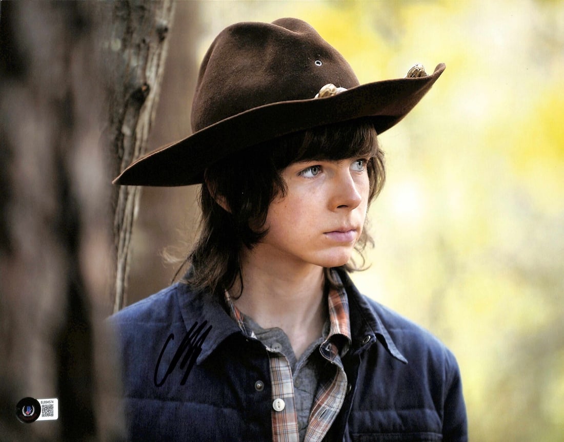 Chandler Riggs Signed 11x14 Carl Grimes Photo Beckett Authenticated: Chandler Riggs Signed 11x14 Carl Grimes Photo Beckett Authenticated This 11x14 photograph features Chandler Riggs, known for his role as "Carl Grimes" in the hit TV series The Walking Dead. The photo 