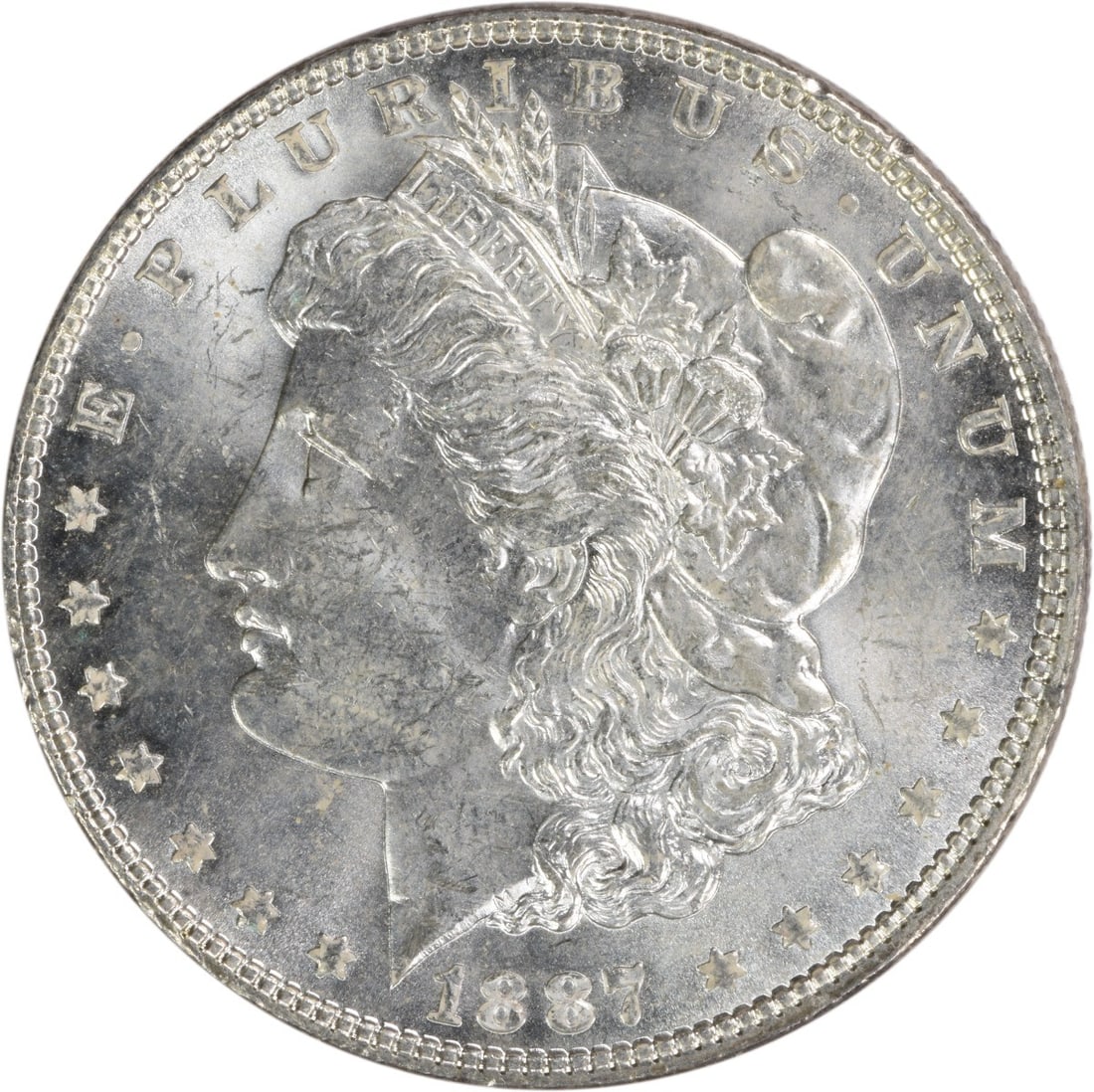 Uncirculated 1887 Morgan Silver Dollar Brilliant Uncirculated Condition: Uncirculated 1887 Morgan Silver Dollar Brilliant Uncirculated Condition This 1887 Morgan Silver Dollar is an uncirculated, pre-owned coin from the United States. It is composed of silver and features 