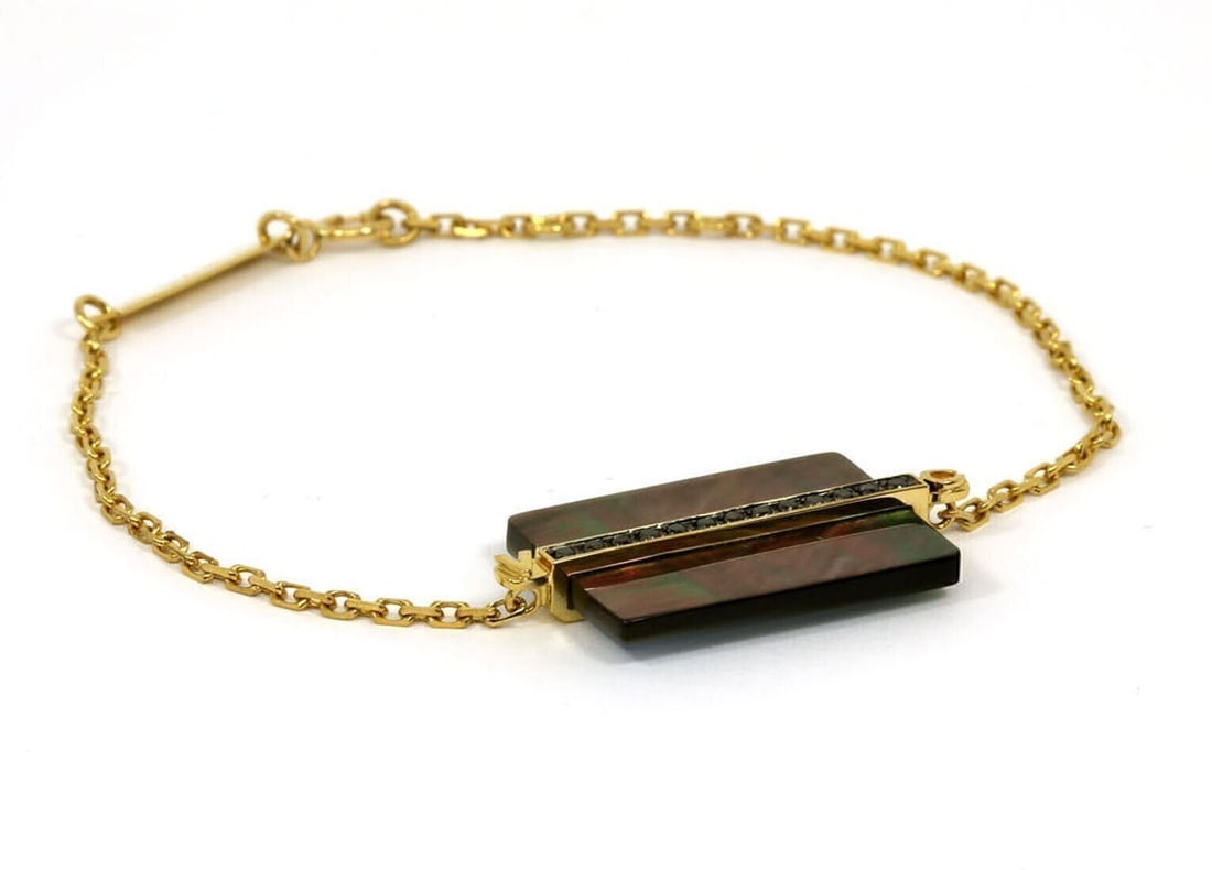 Victoria Casal 18k Yellow Gold Bracelet with Black Diamonds and Gray MOP: Victoria Casal 18k Yellow Gold Bracelet with Black Diamonds and Gray MOP This Victoria Casal bracelet is crafted from 18k yellow gold and features a modern identity (ID) style. The centerpiece is set 