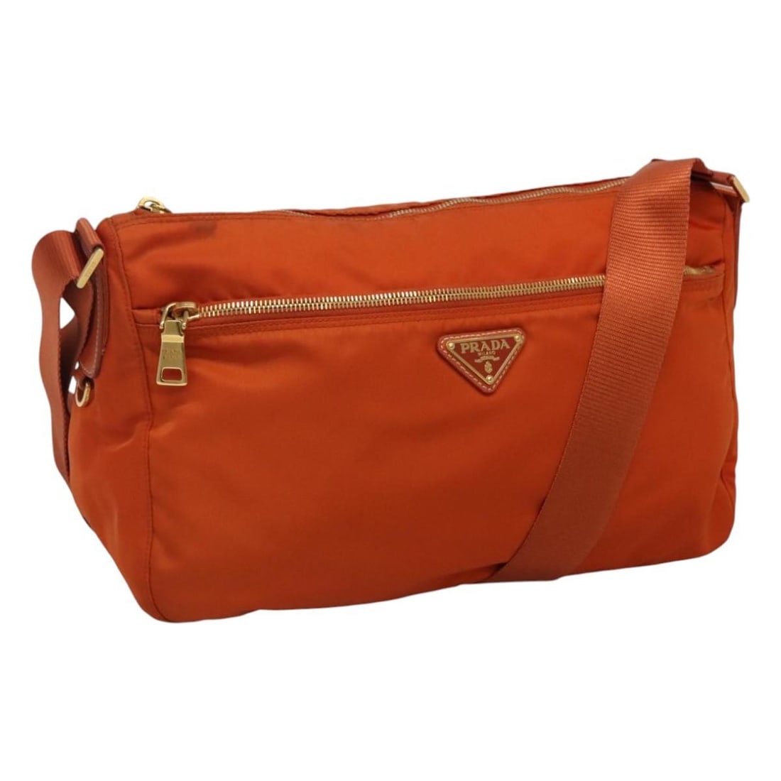Prada Orange Nylon Shoulder Bag with Gold Tone Hardware and Adjustable Strap: Prada Orange Nylon Shoulder Bag with Gold Tone Hardware and Adjustable Strap This PRADA shoulder bag features a stylish orange and gold color combination and is crafted from durable nylon. Designed fo