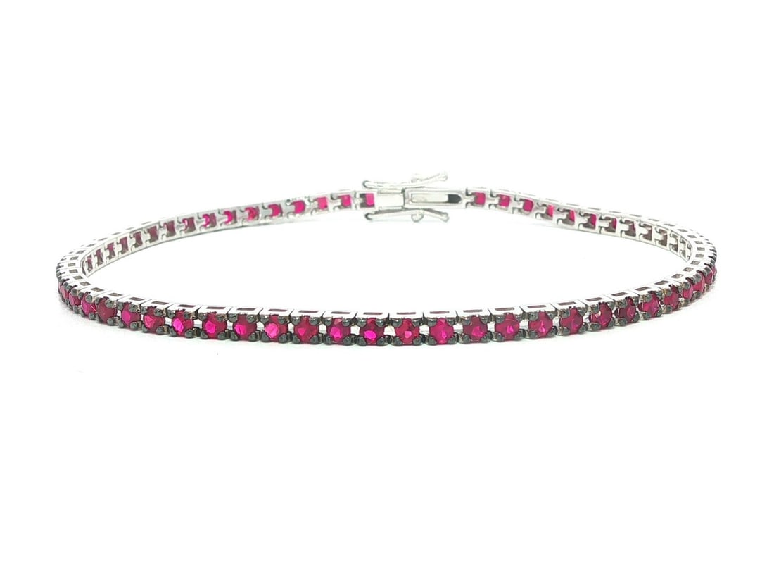2.45ctw Natural Red Ruby Tennis Bracelet in 18k White Gold 6.5 Inch: 2.45ctw Natural Red Ruby Tennis Bracelet in 18k White Gold 6.5 Inch This un-used tennis bracelet features 61 natural round brilliant cut rubies with a total carat weight of 2.45ctw, displaying a vibra