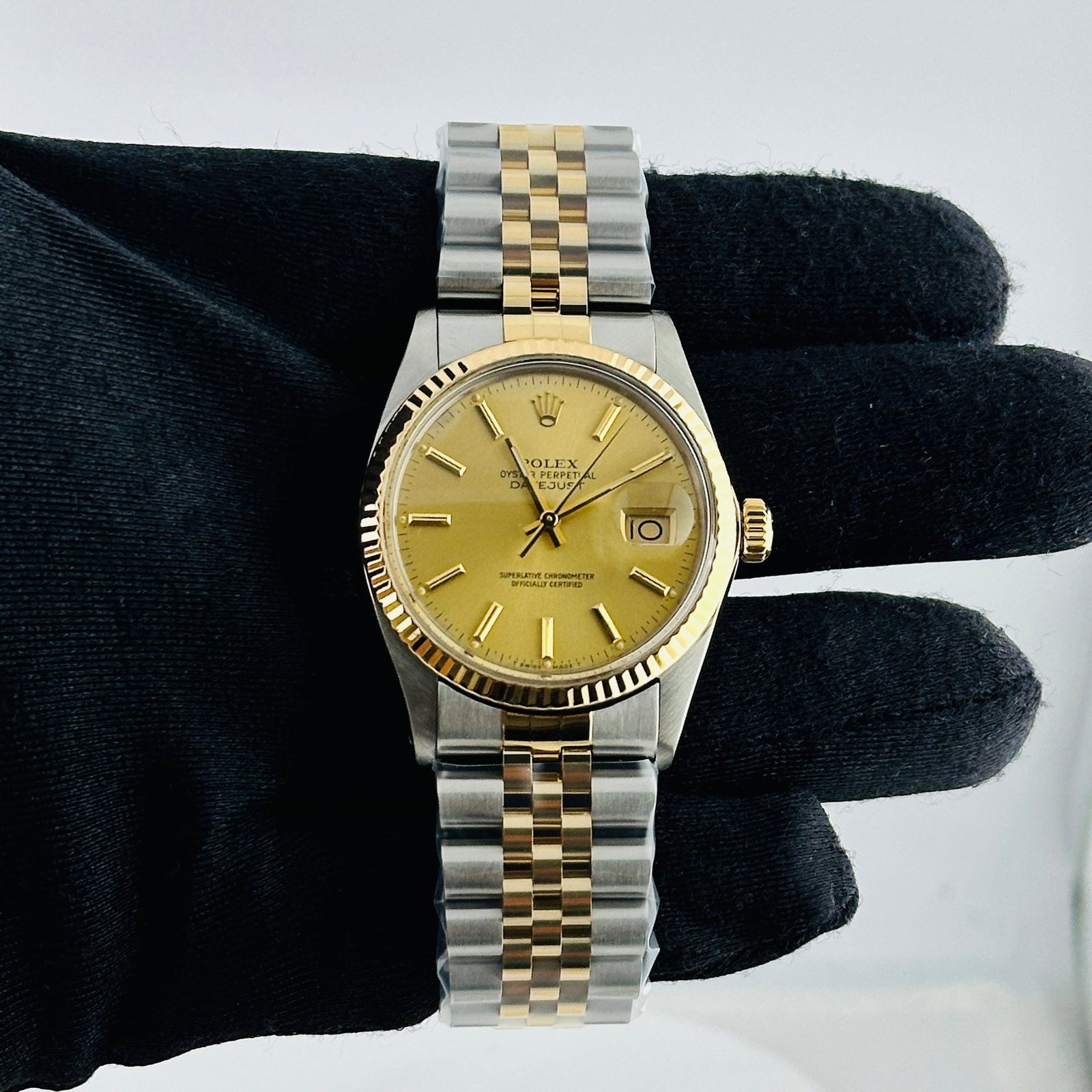Rolex Datejust 16013 Champagne Stick Dial Aftermarket Jubilee Bracelet: Rolex Datejust 16013 Champagne Stick Dial Aftermarket Jubilee Bracelet This is a men's Rolex Datejust wristwatch, reference number 16013. It features a champagne stick dial, a fluted bezel, and is fit