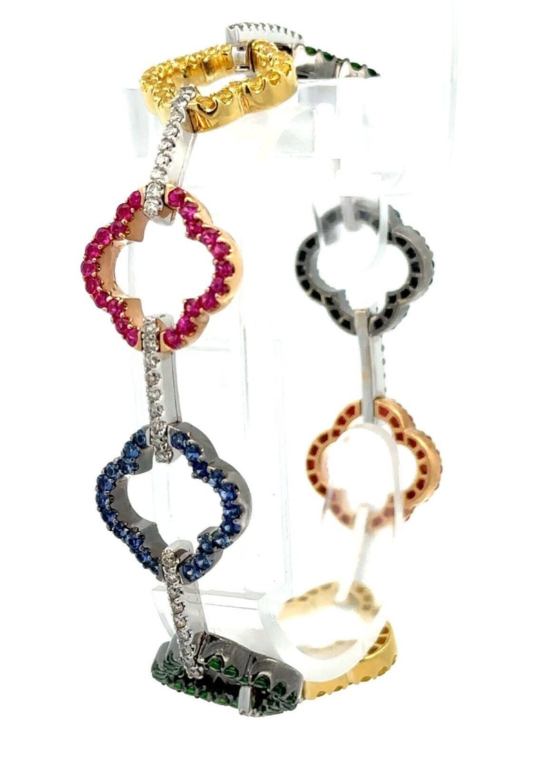 18k Gold Multicolor Sapphire Tsavorite Diamond Flower Link Bracelet: 18k Gold Multicolor Sapphire Tsavorite Diamond Flower Link Bracelet This exquisite bracelet features a stunning open quatrefoil flower design, crafted from solid 18k tri-color gold (yellow, rose, and 