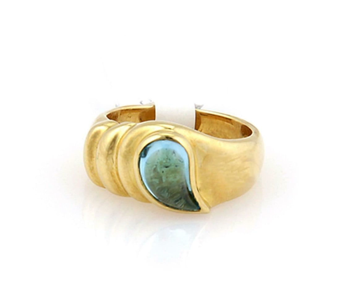 Chopard 18k Yellow Gold Pear Blue Topaz Ring Size 5.5: Chopard 18k Yellow Gold Pear Blue Topaz Ring Size 5.5 This authentic Chopard ring is crafted from 18k yellow gold and features a striking pear-shaped blue topaz set prominently at the front. The vivid