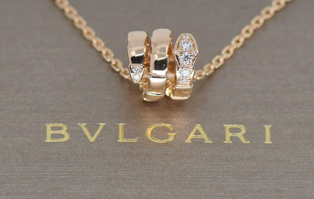 Serpenti Pendant Necklace in 18k Rose Gold with Diamonds by Bulgari: Serpenti Pendant Necklace in 18k Rose Gold with Diamonds by Bulgari This Bulgari Serpenti necklace features a pendant design crafted from 18k rose gold, adorned with diamonds. It is part of the Bvlgar