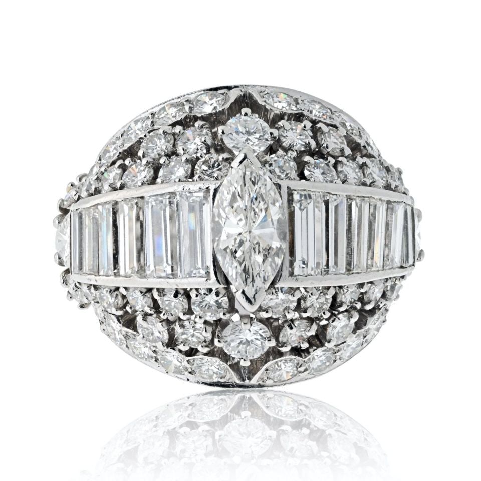 1970s Platinum Bombe Ring with Marquise and Round Cut Diamonds: 1970s Platinum Bombe Ring with Marquise and Round Cut Diamonds Step back into the glamorous 1970s with this exquisite Platinum Diamond Bombe Ring, a stunning example of vintage elegance and craftsmans