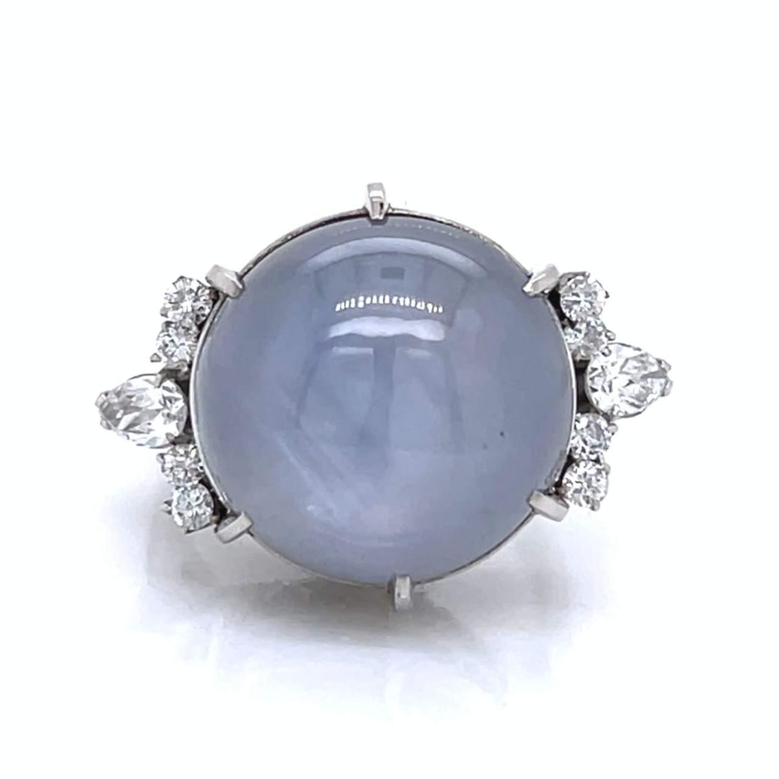 Platinum 24.60 Ct Star Sapphire Diamond Ring 10 Diamonds: Platinum 24.60 Ct Star Sapphire Diamond Ring 10 Diamonds This exquisite ring features a stunning 24.60 Ct. star sapphire, elegantly set in luxurious platinum. Accentuating the rich blue hue of the sap