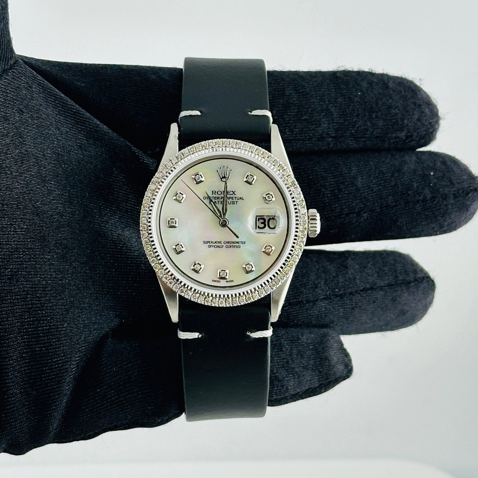 Datejust Ref 1601 Mens Watch With Aftermarket MOP Diamond Dial and Leather Strap: Datejust Ref 1601 Mens Watch With Aftermarket MOP Diamond Dial and Leather Strap This Rolex Datejust men's watch features an aftermarket white mother-of-pearl diamond dial, a prong-set diamond bezel, 