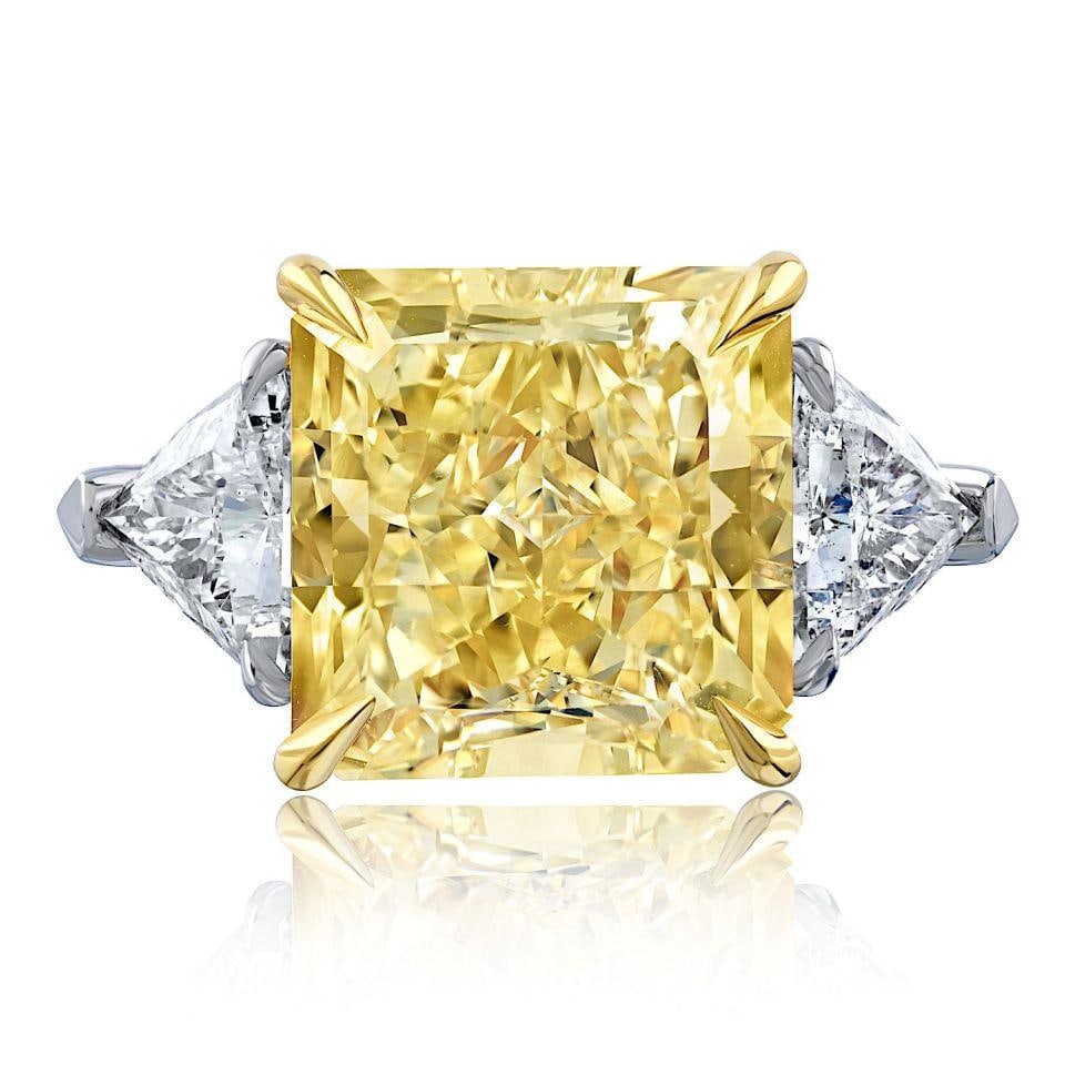 10.81ct Fancy Yellow Radiant Cut Three Stone Engagement Ring: 10.81ct Fancy Yellow Radiant Cut Three Stone Engagement Ring This stunning three stone engagement ring features a breathtaking 10.81 carat radiant cut diamond at its center, showcasing a fancy yellow 