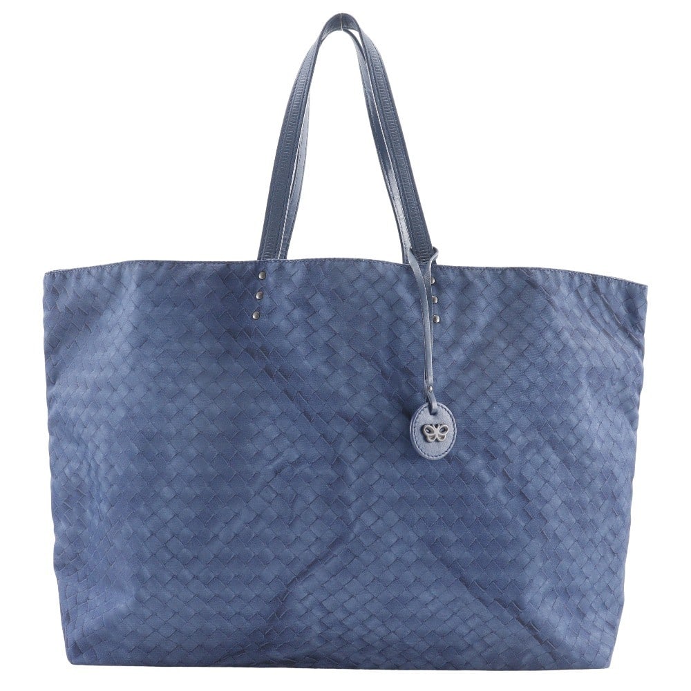 Intrecciolusion Navy Nylon Tote Bag by Bottega Veneta: Intrecciolusion Navy Nylon Tote Bag by Bottega Veneta This Bottega Veneta Intrecciolusion Tote is crafted from printed navy nylon, offering a stylish and versatile design suitable for all genders. Mad