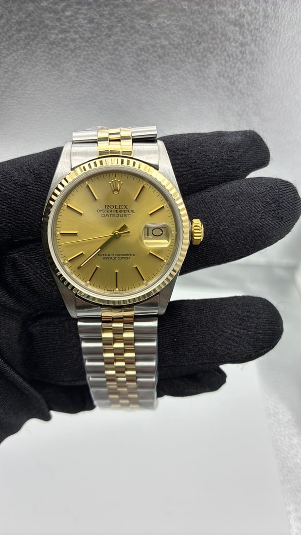 Rolex Datejust 16013 Champagne Stick Dial Aftermarket Jubilee Bracelet: Rolex Datejust 16013 Champagne Stick Dial Aftermarket Jubilee Bracelet This is a men's Rolex Datejust watch, reference number 16013, featuring a champagne stick dial and a fluted bezel. The watch is p