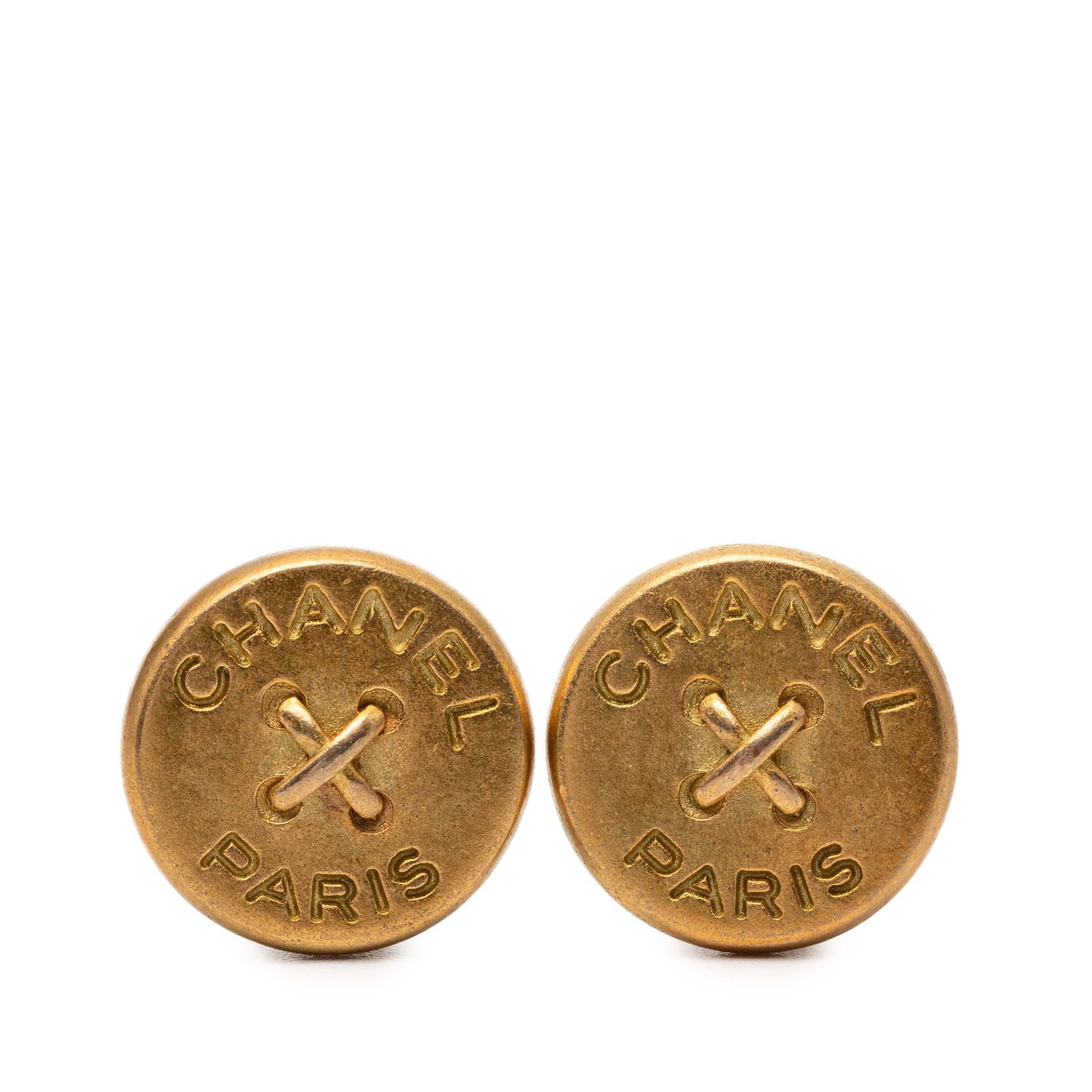 Chanel Engraved Logo Gold Tone Clip On Button Earrings: Chanel Engraved Logo Gold Tone Clip On Button Earrings These Chanel clip-on earrings feature a round button design with a gold-tone metal finish and engraved logo detailing. Designed for non-pierced e