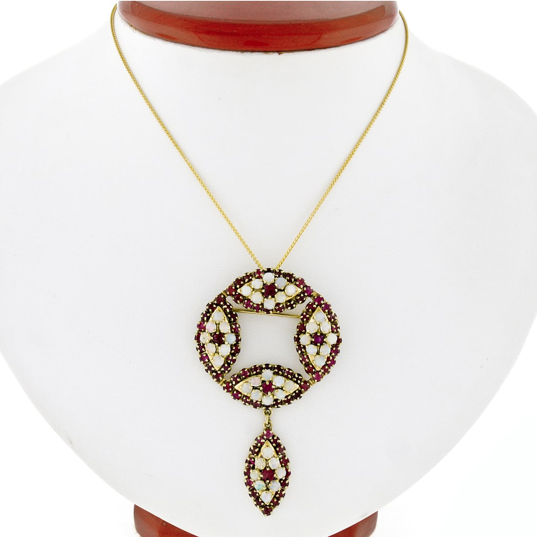 14k Yellow Gold Ruby Opal Marquise Pendant Brooch: 14k Yellow Gold Ruby Opal Marquise Pendant Brooch This vintage pendant and brooch is expertly crafted from solid 14k yellow gold and showcases a striking marquise design. The piece features a total of