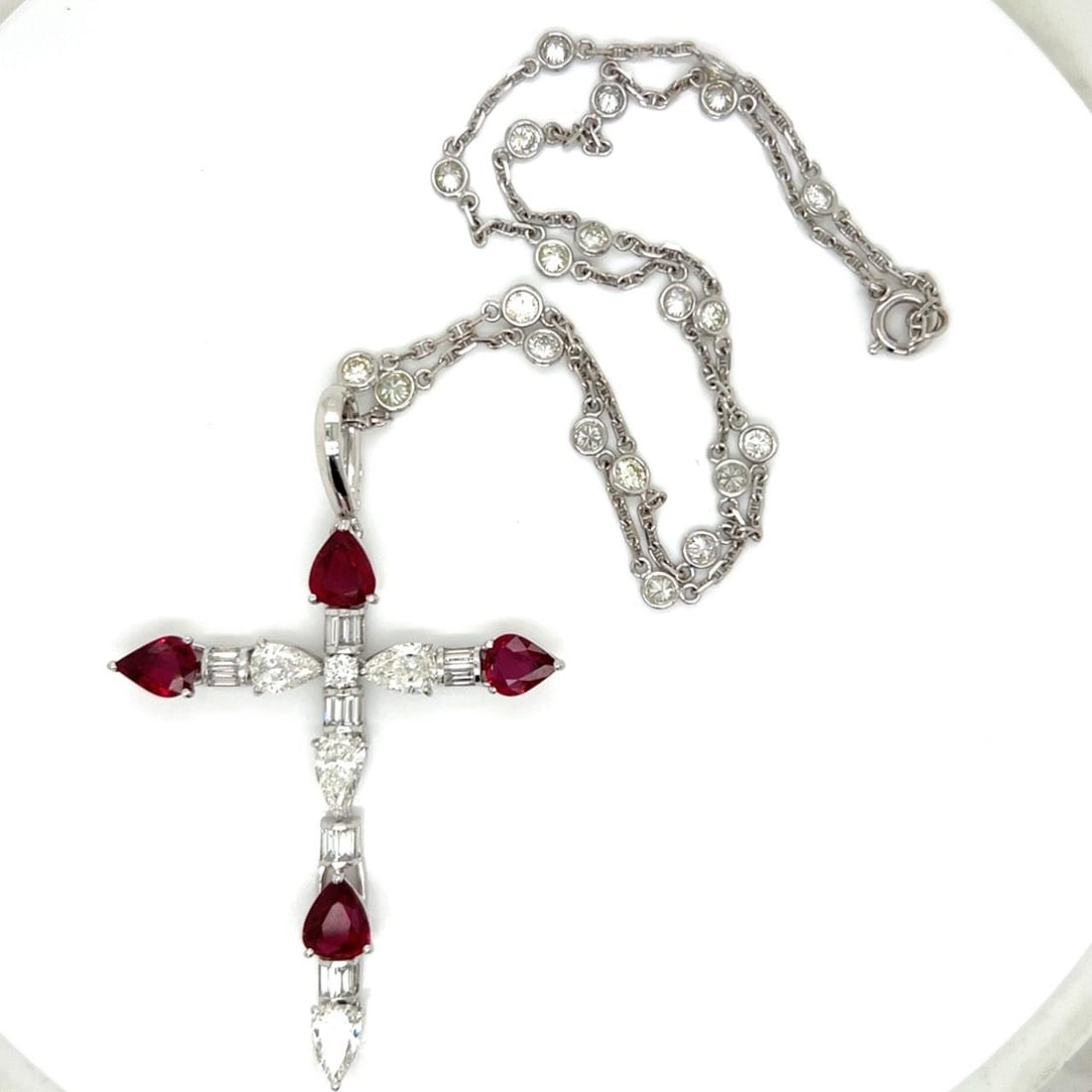 GIA Certified Ruby and Diamond Cross Pendant Necklace in 18K White Gold: GIA Certified Ruby and Diamond Cross Pendant Necklace in 18K White Gold This French pendant necklace features a cross design crafted from 18K white gold. The pendant is adorned with four GIA certified