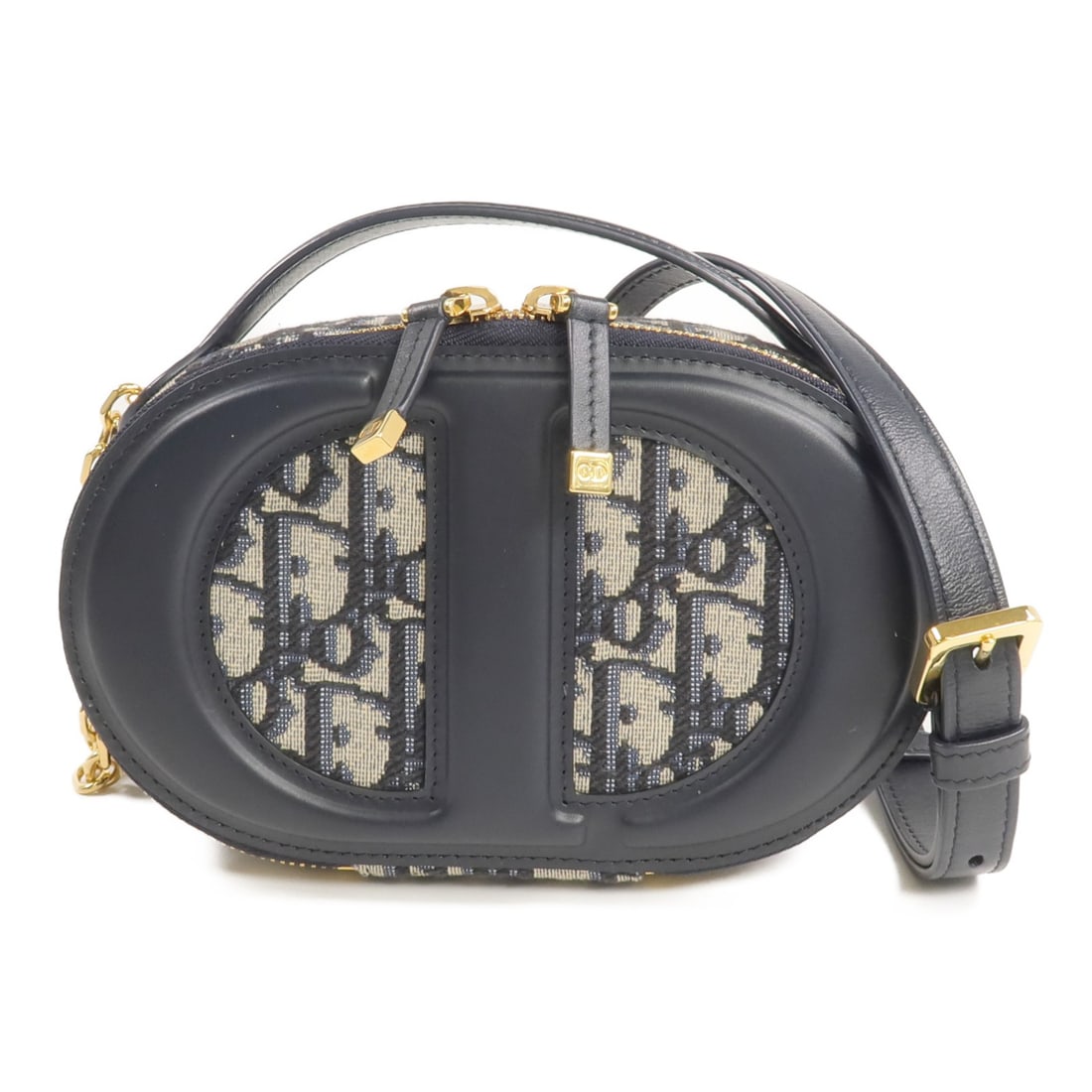 Dior Navy Canvas Leather Oval Camera Bag with Gold Hardware: Dior Navy Canvas Leather Oval Camera Bag with Gold Hardware This Christian Dior camera bag features a two-way design, crafted with navy canvas and leather. The bag showcases an oval silhouette with CD
