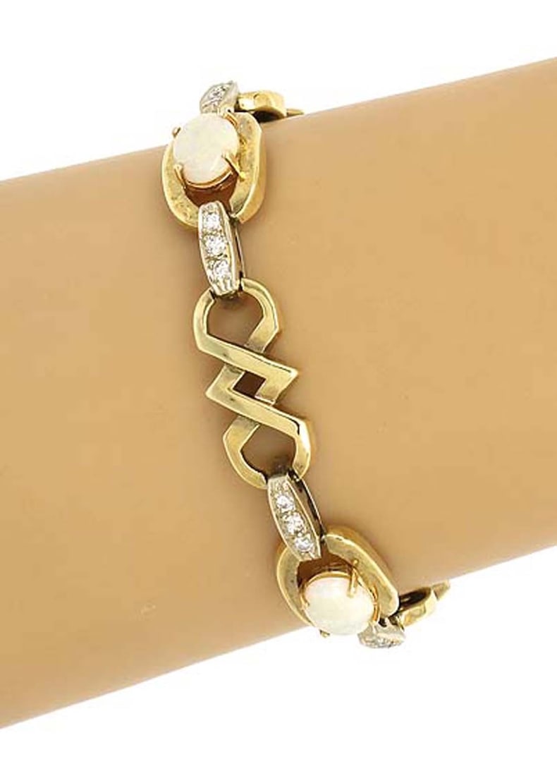 14k Two Tone Gold Opal Diamond Link Bracelet: 14k Two Tone Gold Opal Diamond Link Bracelet This vintage estate bracelet features a sophisticated fancy link design crafted from 14k yellow and white gold. It is adorned with luminous opals totaling 