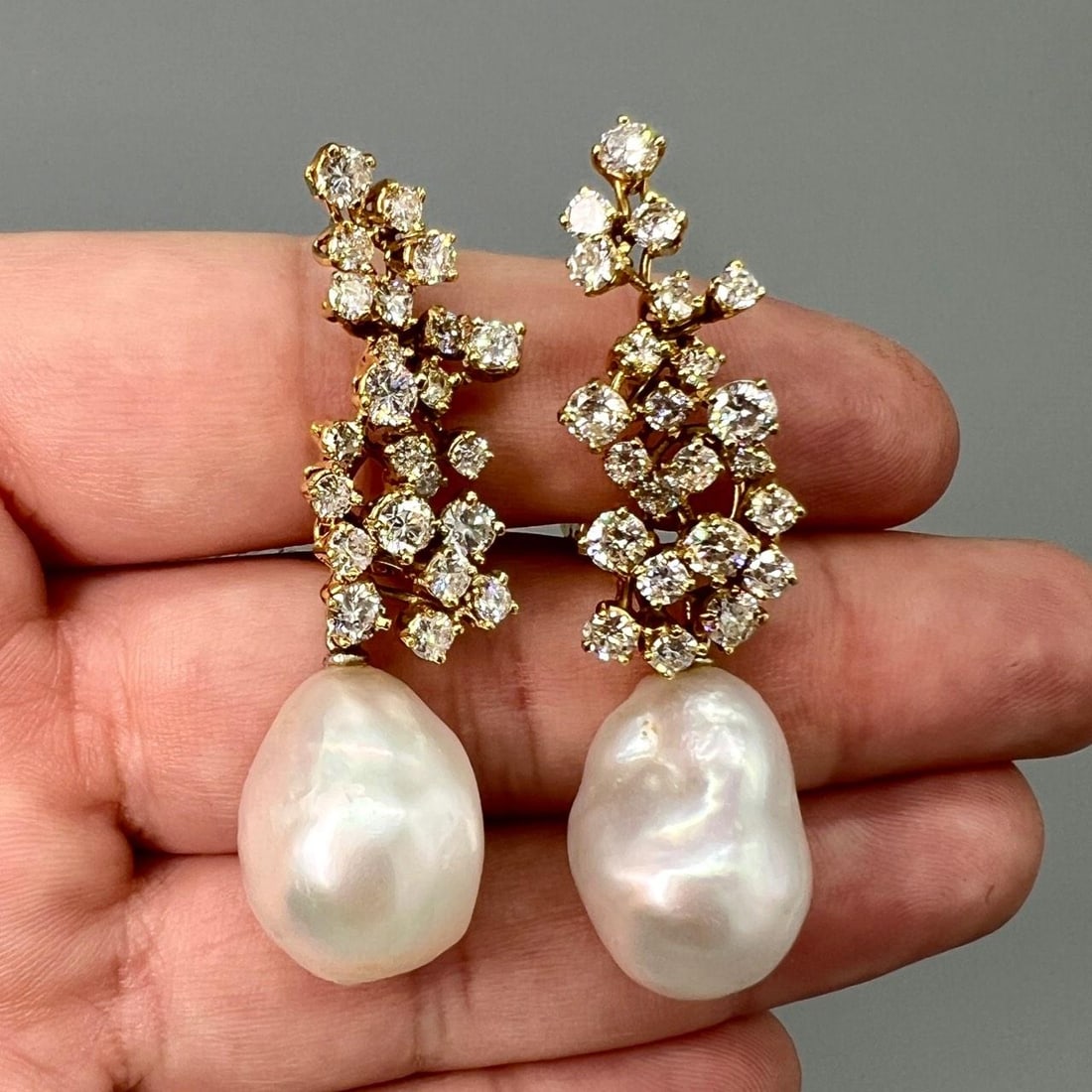 South Sea Pearl and Diamond Drop Earrings in 18K Yellow Gold: South Sea Pearl and Diamond Drop Earrings in 18K Yellow Gold These elegant earrings are crafted from 18K yellow gold and feature South Sea pearls accented by 46 diamonds with an approximate total weig
