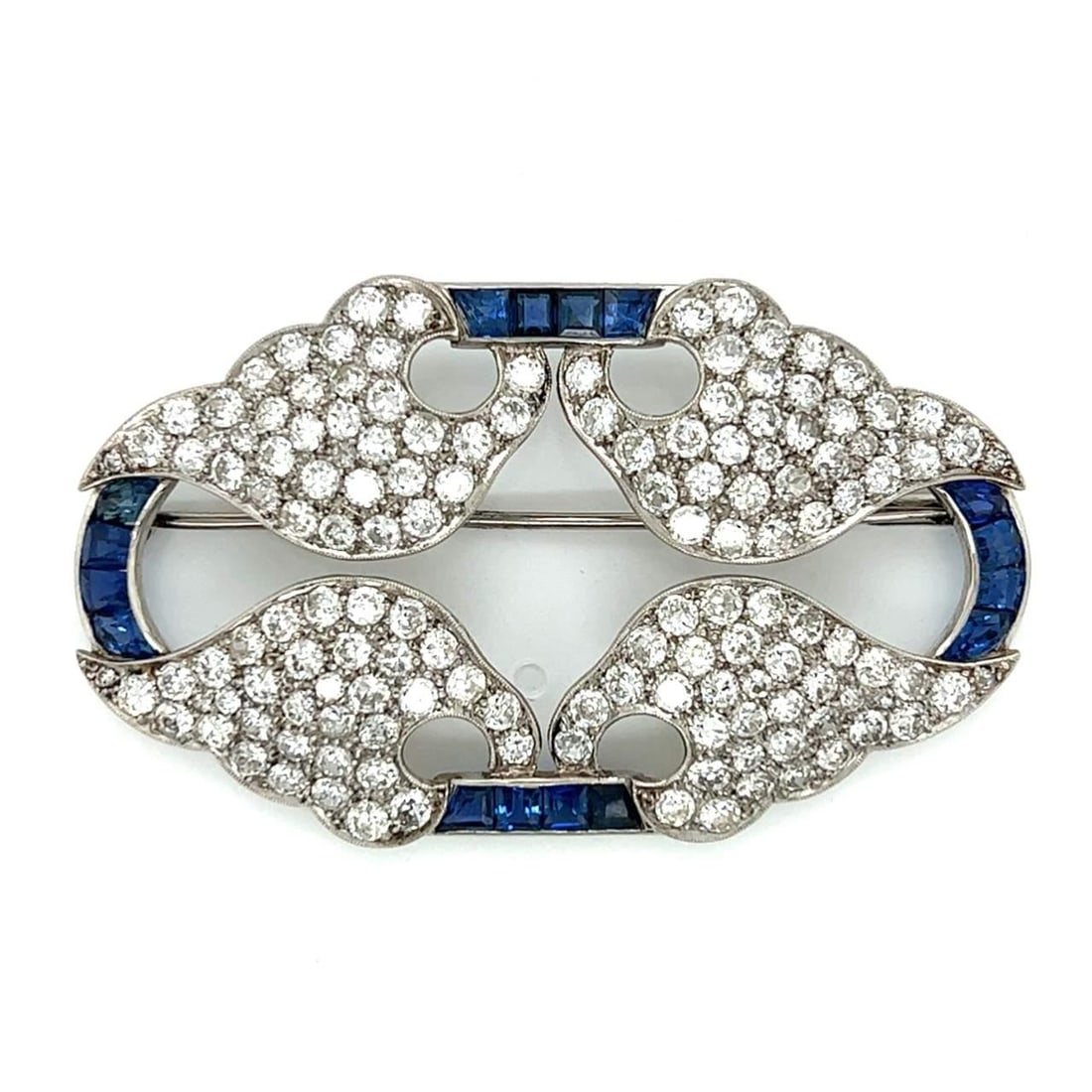 Art Deco Platinum Brooch with 144 Diamonds and 16 Sapphires: Art Deco Platinum Brooch with 144 Diamonds and 16 Sapphires This exquisite Art Deco brooch is crafted from platinum and features a stunning arrangement of 144 diamonds, totaling approximately 12.00 ca