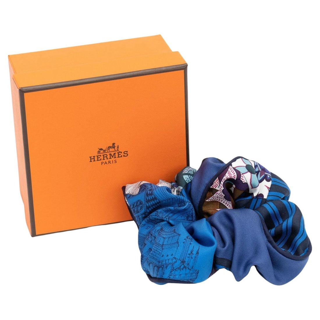 Silk Patchwork de Sole Scrunchie by Hermes in Black and Blue with Box: Silk Patchwork de Sole Scrunchie by Hermes in Black and Blue with Box Hermes black and blue silk scrunchie featuring a Patchwork de Sole Imprimee design. Includes the original box. Item is un-used. Sp