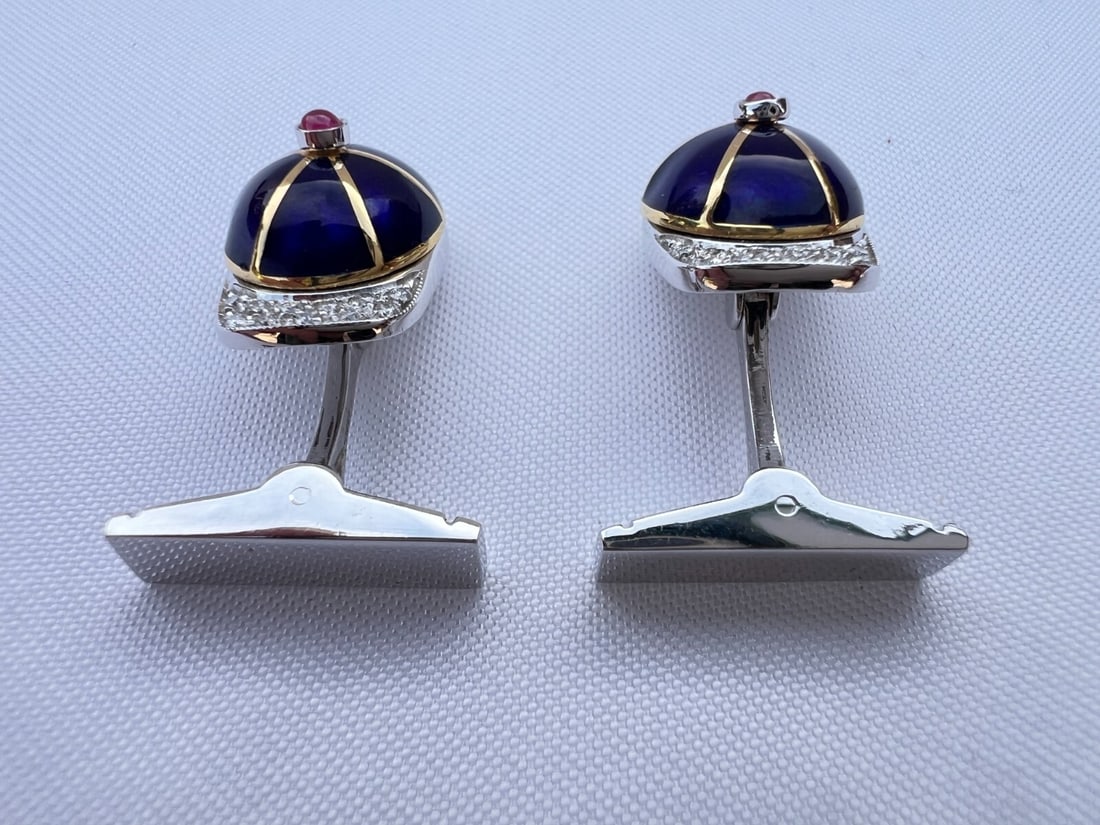 De Mari 18K Gold Diamond Ruby Enamel Jockey Cup Cufflinks: De Mari 18K Gold Diamond Ruby Enamel Jockey Cup Cufflinks Discover the elegance of this exquisite pair of cufflinks by De Mari, featuring a striking jockey cup design crafted from 18K white and yellow